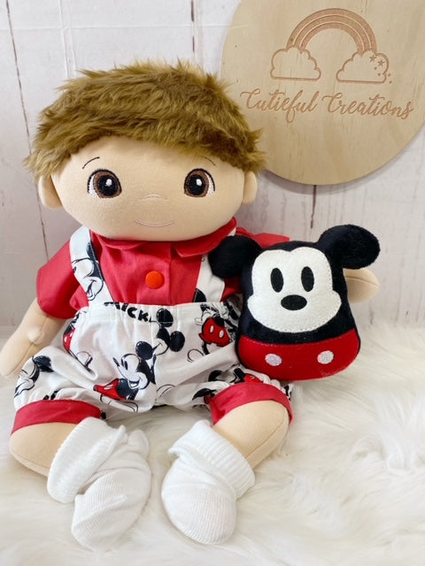 Laura Allen has made a cute boy cloth doll adorned in sweet disney overalls